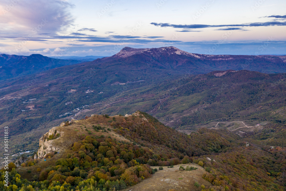 yellow autumn mountains against a background of blue haze and storm clouds yellow autumn mountains against a background of blue haze and storm clouds