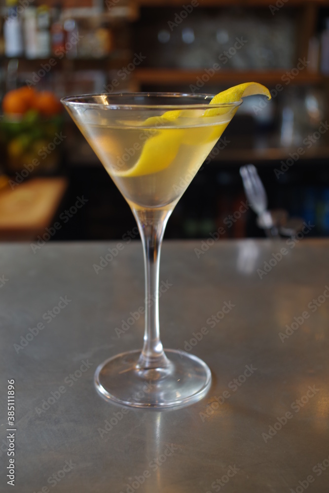 Martini cocktail with a lemon twist in a bar