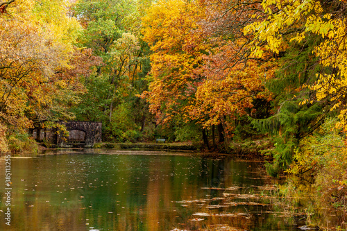Paradise Springs State Natural Area with colorful autumn trees reflecting in the pond with the old spring house.
