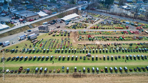 Aerial View of an Amish Mud Sale with Lots of Buggies and Farm Equipment