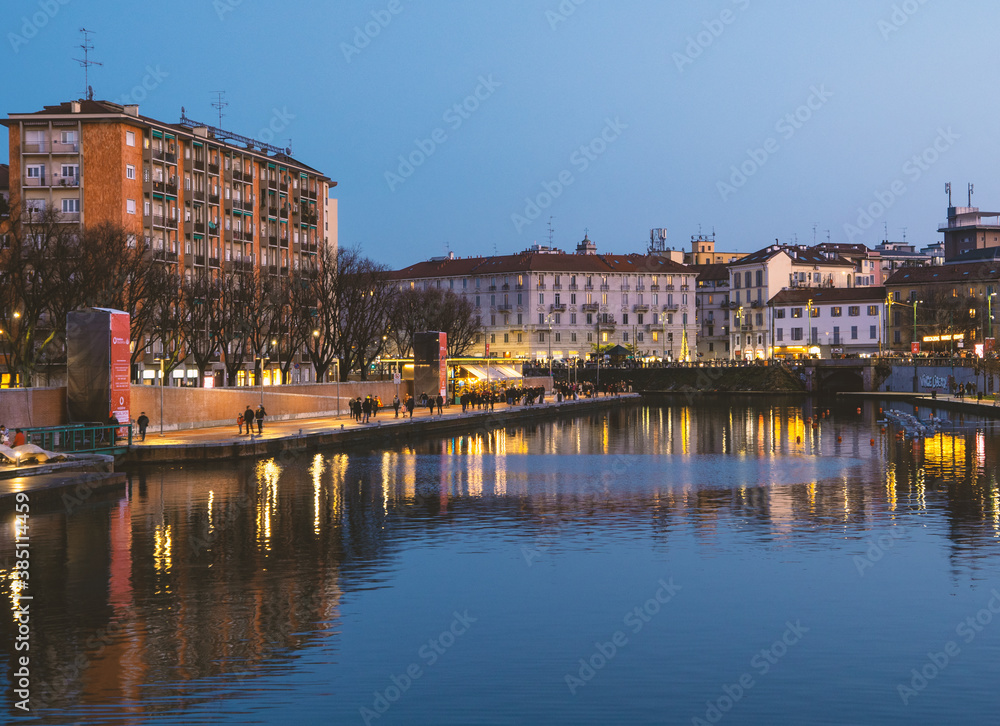Stunning blue hour view of Darsena in the touristic district of Milan. Large body of water where the lights of the city are reflected. Lombardy, Italy