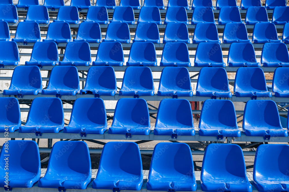 Stadium seats background. Rows of blue plastic empty chairs Stadium seats background. Rows of blue plastic empty chairs