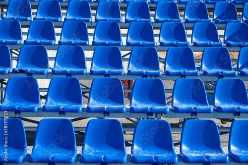Stadium seats background. Rows of blue plastic empty chairs