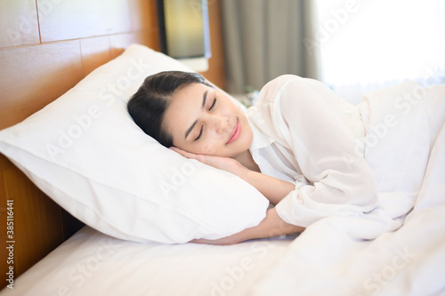 Young beautiful woman sleeping in her bed at home