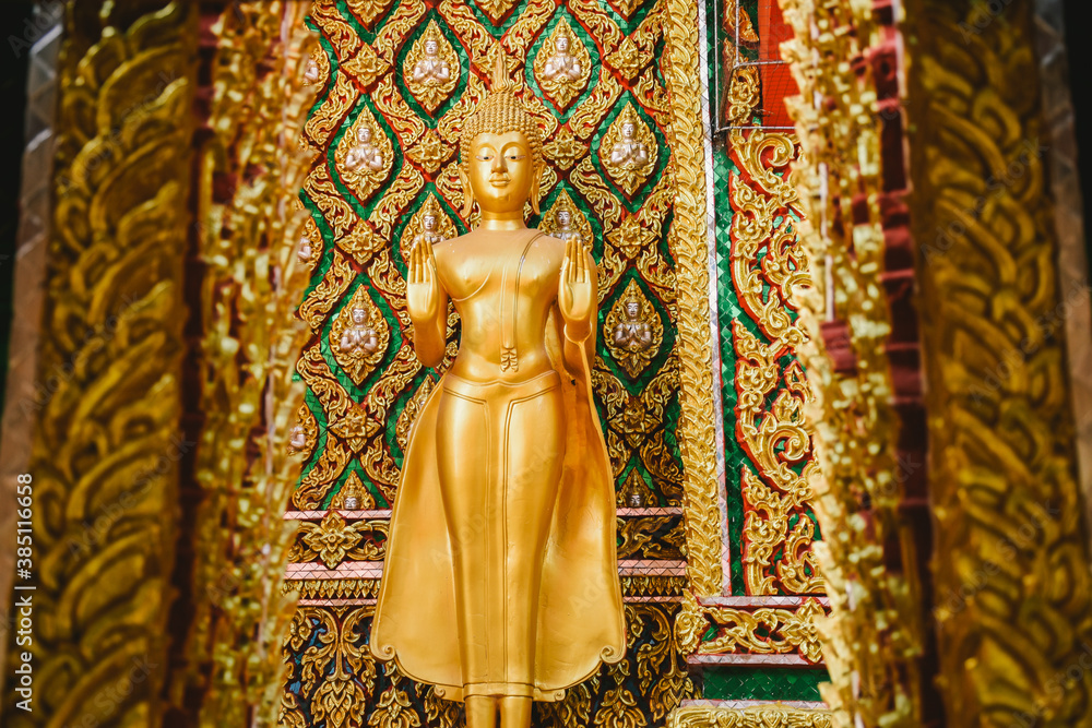  Buddha statue with beautiful details of Thai fine arts background at Buddhist temple.

