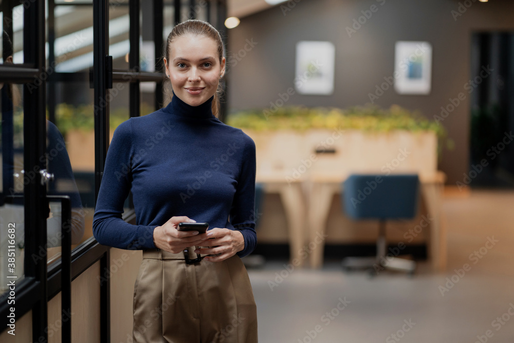 comfortable office stylish clothes, favorite work. businesswoman manager a young woman holds a phone in her hands, writes to her partner, makes an online order on the website for lunch