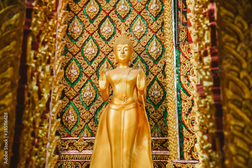  Buddha statue with beautiful details of Thai fine arts background at Buddhist temple. 