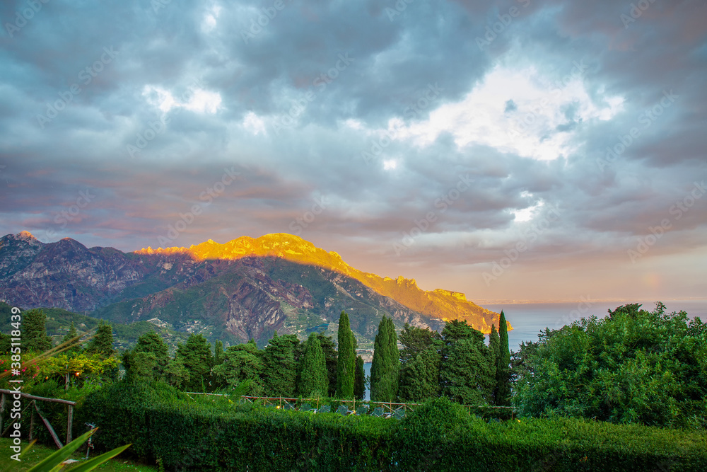 Wonderful views of Villa Cimbrone and other surrounding mountains. A ray of the sun hits and paints yellow one mountain in the distance.