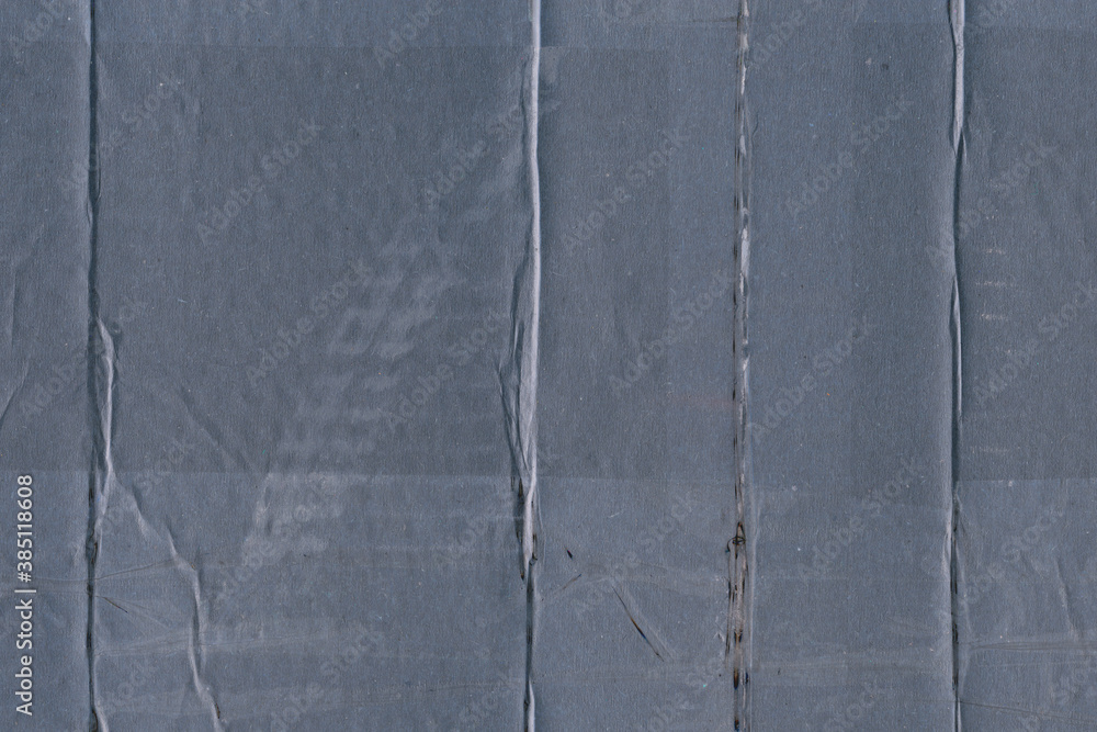 Fototapeta premium A blue vintage rough sheet of carton. Recycled environmentally friendly cardboard paper texture. Simple minimalist papercraft background.
