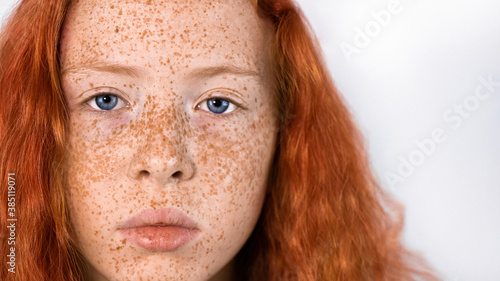 Portrait of a red-haired girl with freckles