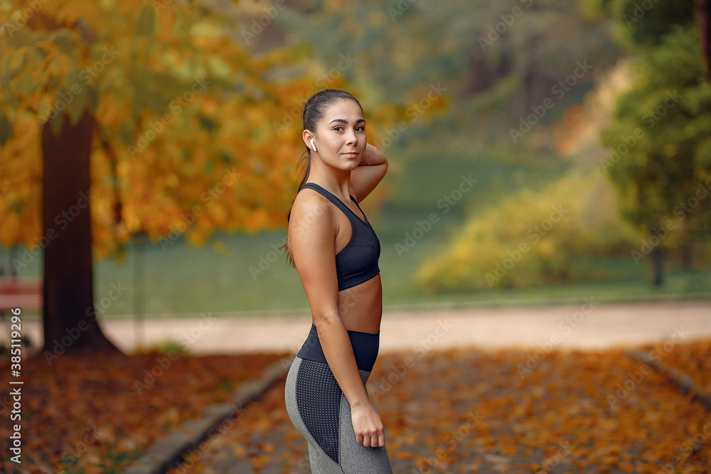 Beautiful girl training. Sports girl in a sportswear. Brunette in a black top Beautiful girl training. Sports girl in a sportswear. Brunette in a black top