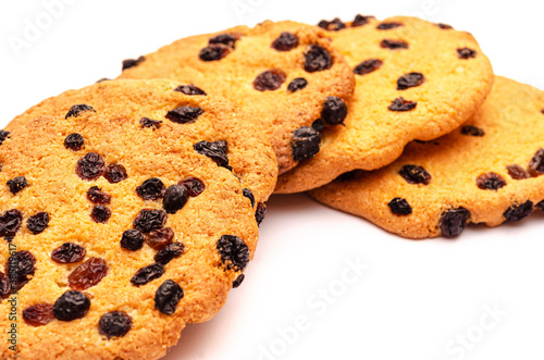 Many large cookies with raisins on a white background