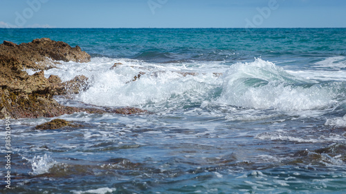 Sea waves break against the rocky coastline in Sierra de Irta Natural Park  Castellon  Spain