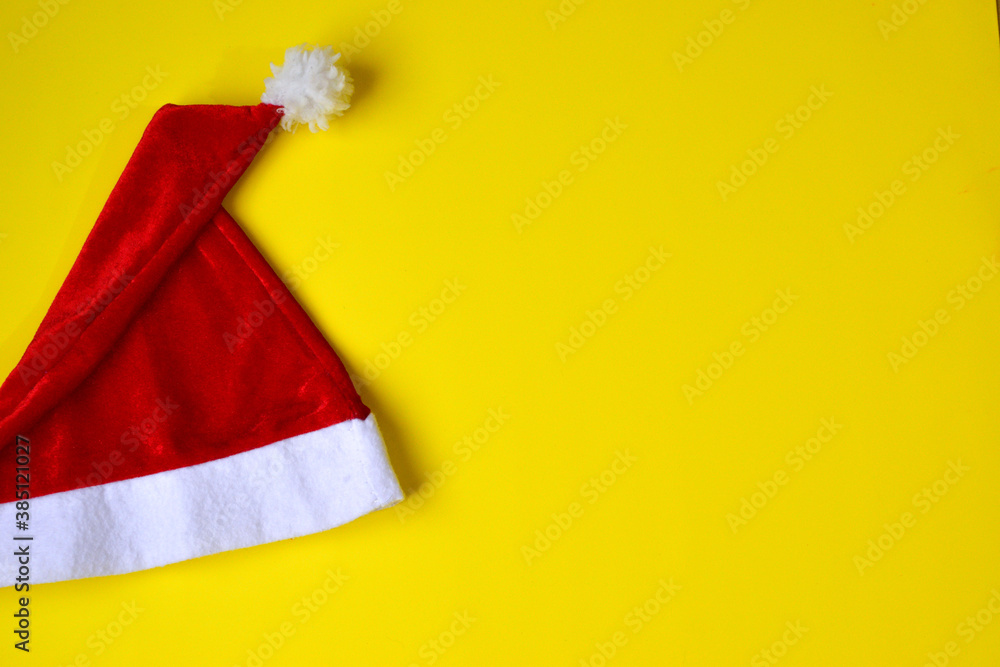 santa claus christmas hat on yellow background - ready to celebrate christmas santa claus christmas hat on yellow background - ready to celebrate christmas