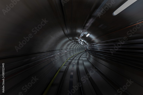 Construction site of the subway tunnel with blurred light tracks. Underground facility leading deep down.