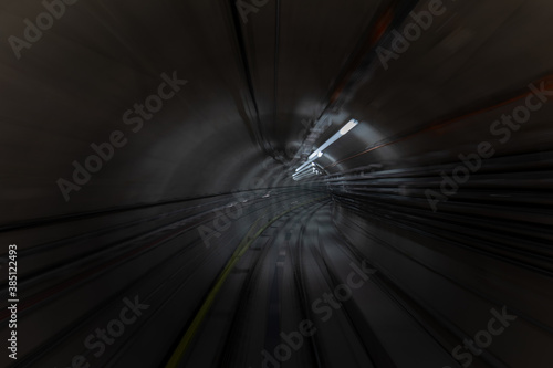 Construction site of the subway tunnel with blurred light tracks. Underground facility leading deep down.