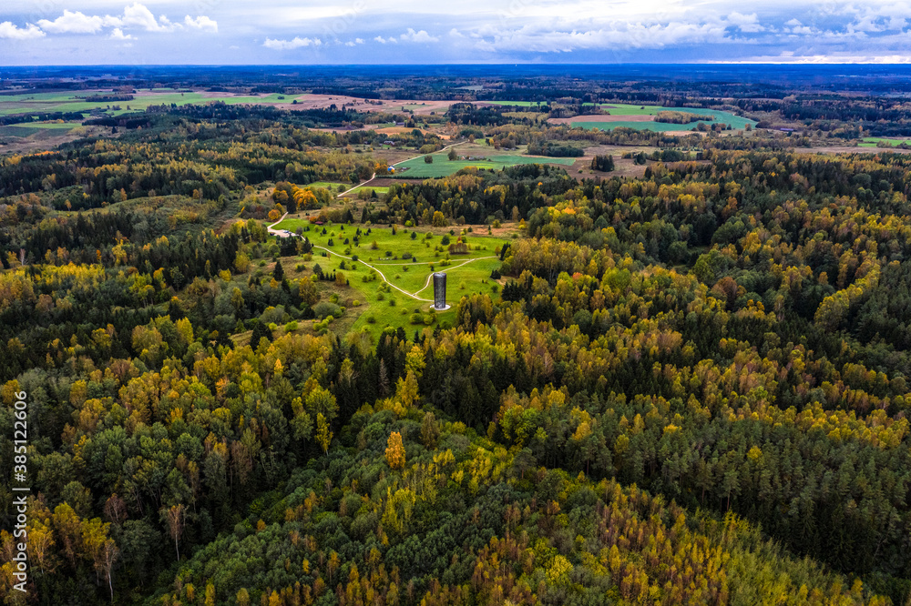 Aerial view of observation tower in colorful woodland in autumn
