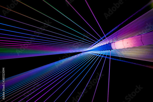 colourful and abstract view of modern suspension bridge architecture during the night