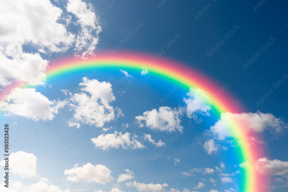Blue sky with clouds and rainbow
