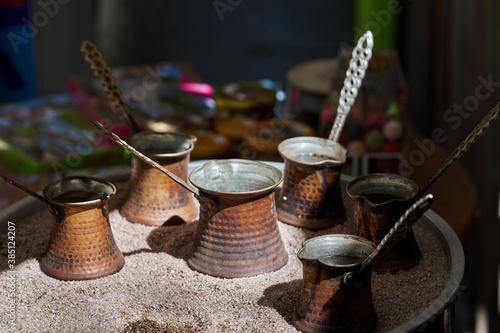 Group of copper Turks with coffee in hot sand
