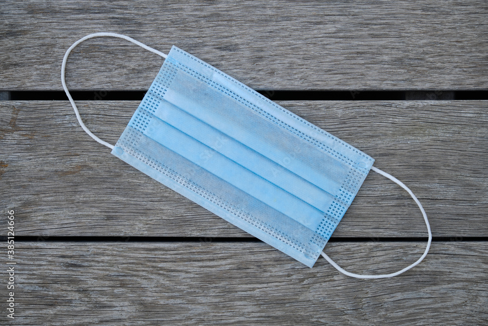 blue medical mask on gray boards blue medical mask on gray boards