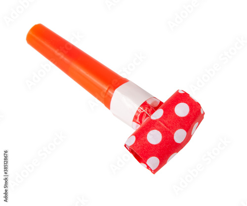 Rolled festive noisemaker or party whistle horn on the white