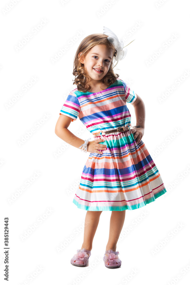 happy little girl wearing colorful dress posing in studio, isolated on white happy little girl wearing colorful dress posing in studio, isolated on white