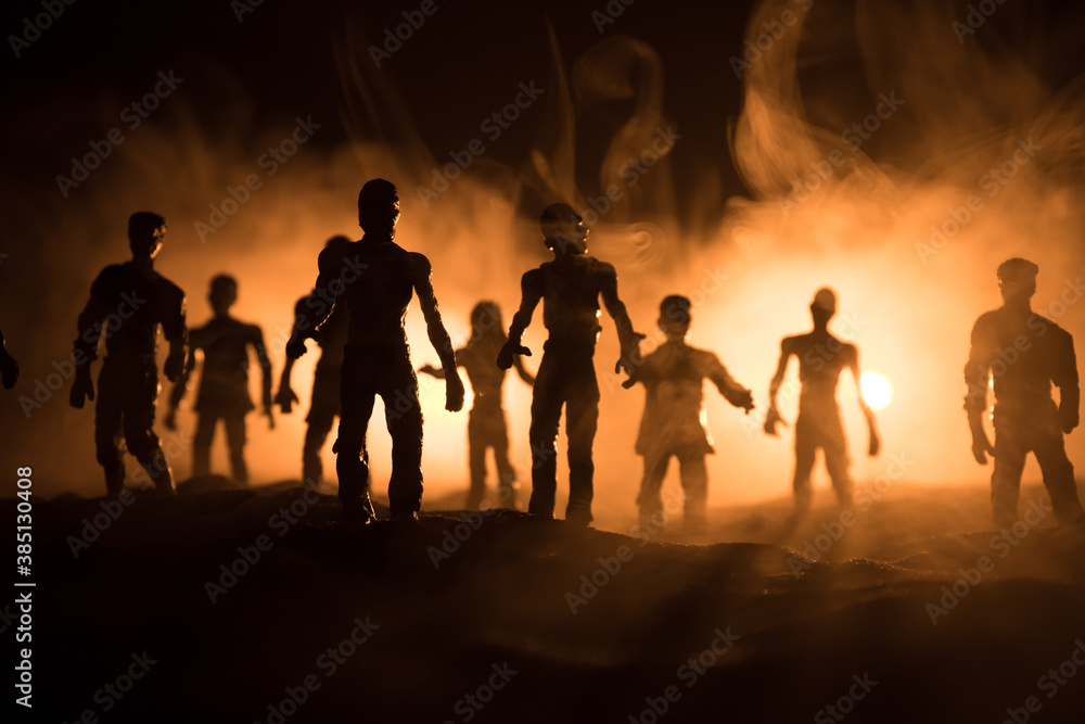 Scary view of zombies at cemetery dead tree, moon, church and spooky cloudy sky with fog, Horror Halloween concept with glowing pumpkin. Selective focus Scary view of zombies at cemetery dead tree, moon, church and spooky cloudy sky with fog, Horror Halloween concept with glowing pumpkin. Selective focus
