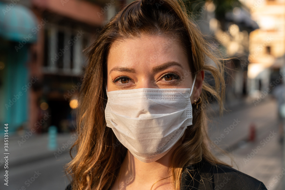 Blonde woman wearing a protective mask on the street. Blonde woman wearing a protective mask on the street.
