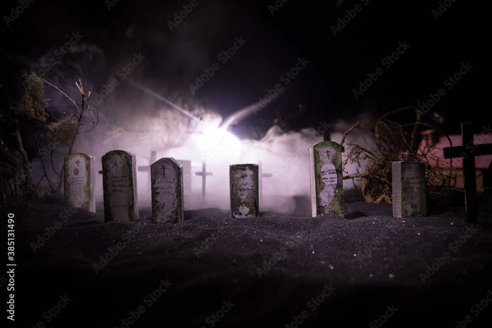 Scary view of zombies at cemetery dead tree, moon, church and spooky cloudy sky with fog, Horror Halloween concept with glowing pumpkin. Selective focus Scary view of zombies at cemetery dead tree, moon, church and spooky cloudy sky with fog, Horror Halloween concept with glowing pumpkin. Selective focus
