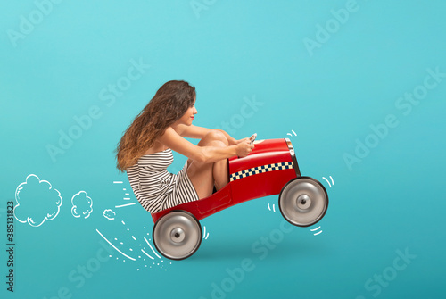 Tablou pe pânză Reckless girl is driving very fast the car