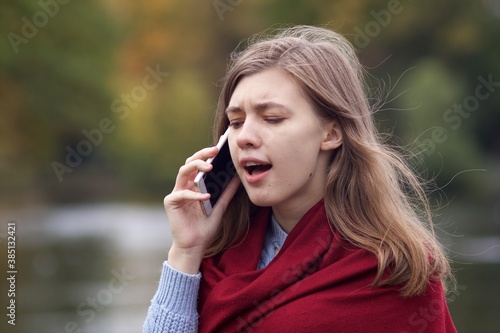 Nervous frustrated angry young woman, irritated girl talking on cell mobile phone, having negative conversation on smartphone, screaming