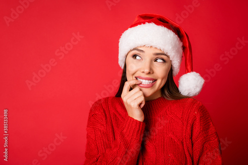 Close-up portrait of her she nice attractive pretty lovely cheerful curious girl creating solution biting nail looking aside copy space isolated over bright vivid shine vibrant red color background
