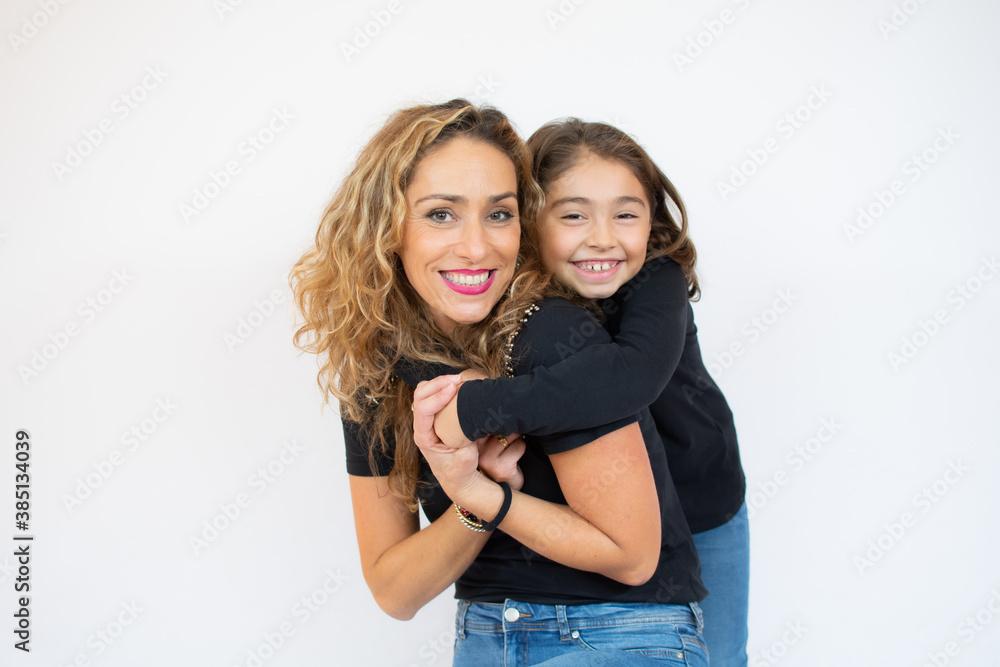 Mother giving piggyback to her daughter isolated on white Mother giving piggyback to her daughter isolated on white