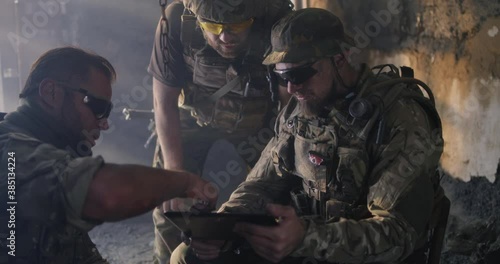Soldier showing region plan to commander