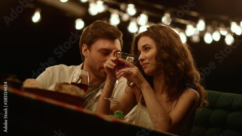 Man flirting with woman at romantic date. Cheerful couple talking together photo