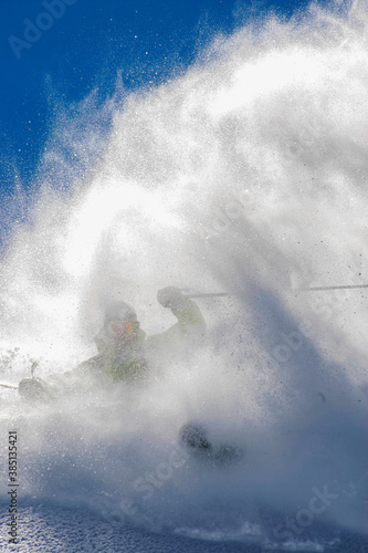 Skier generating a spray of snow
