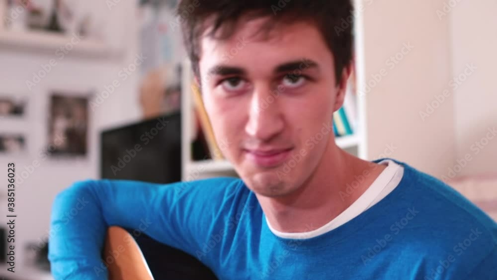Guy makes a blog on guitar playing. Movement along the strings, gestures showing hello to subscribers. Exchange of knowledge in communication. Guy makes a blog on guitar playing. Movement along the strings, gestures showing hello to subscribers. Exchange of knowledge in communication.