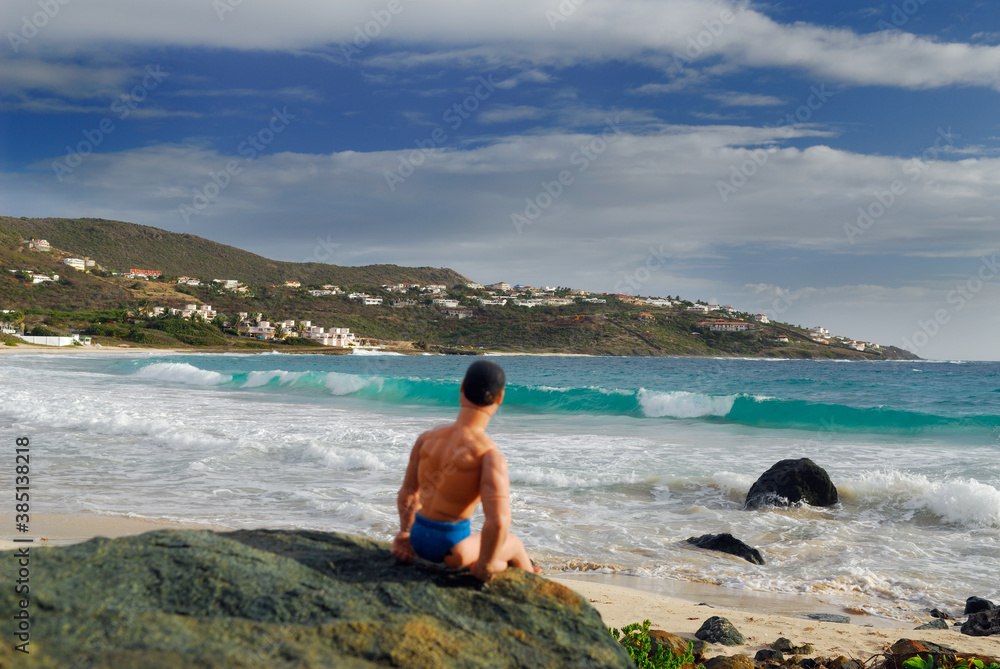 Muscle man doll watching the surf on Guana Bay Beach