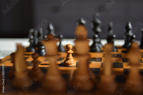 Chess set with pawn in spotlight