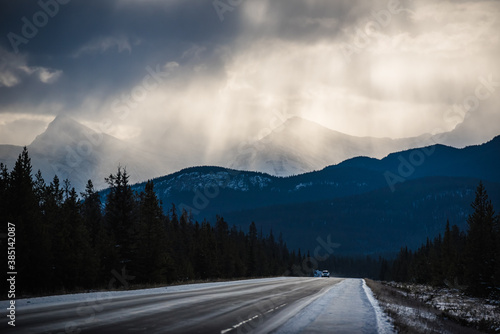 Sunrays through cloudy skies seen from the Trans Canada Highway between Banff and Jasper. Alberta, Canada.