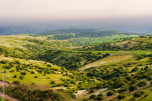Spectacular landscape to beautiful green hills with bushes and trees on a sunny day in Northern Iran
