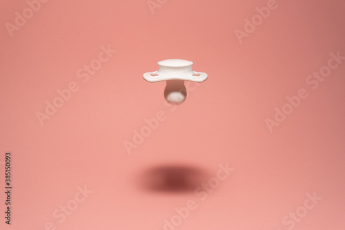 Abstract flying white baby pacifier photo