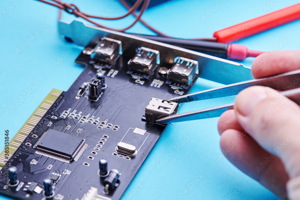 © Andrii - technician worker repairing electronic hardware. digital device service concept