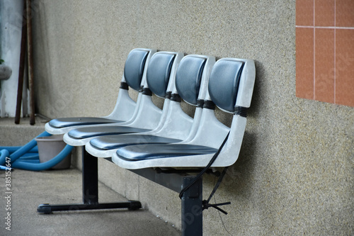 Plastic chair set for support and service to customer install and put on beautiful texture of concrete floor and wall in swimming pool area.