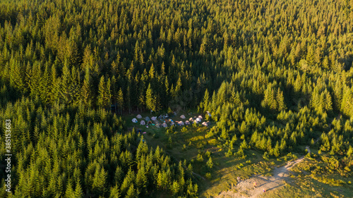 Hiker's camp in morning forest in mountains. Top view