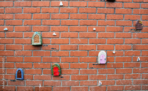 Fairy doors on red brick wall in Dublin, Ireland