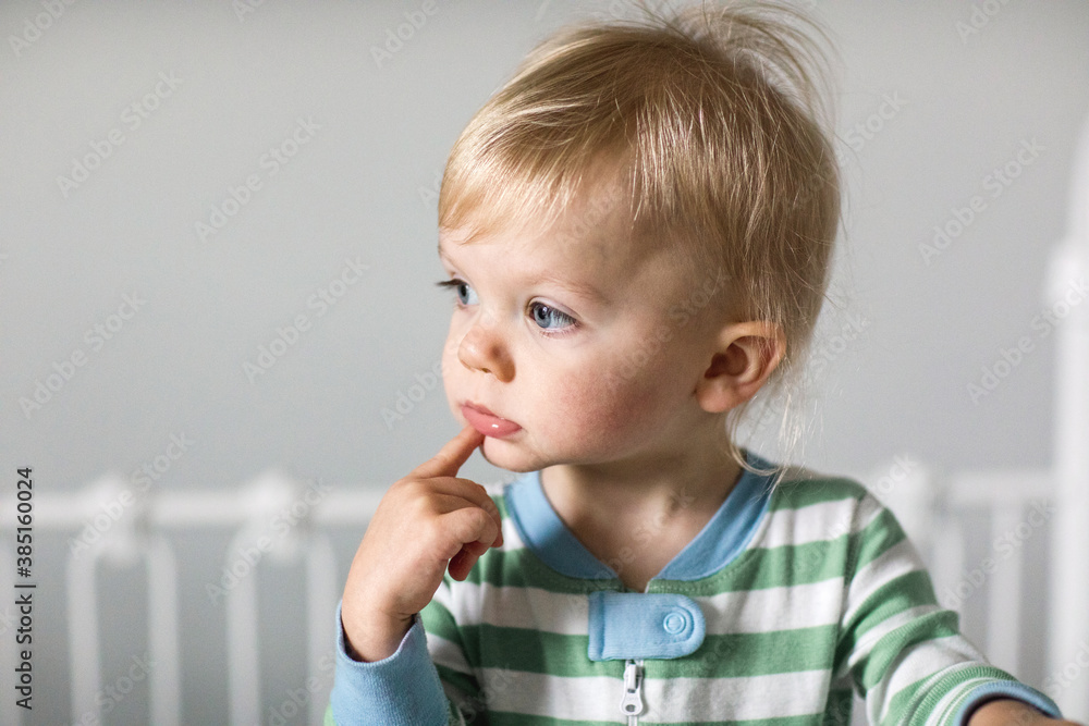 portrait of a toddler standing in his crib portrait of a toddler standing in his crib