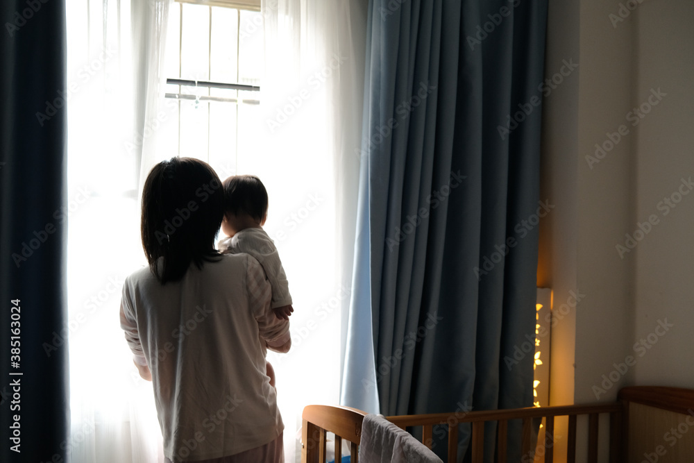 Asian mother and cute baby in bedroom Asian mother and cute baby in bedroom