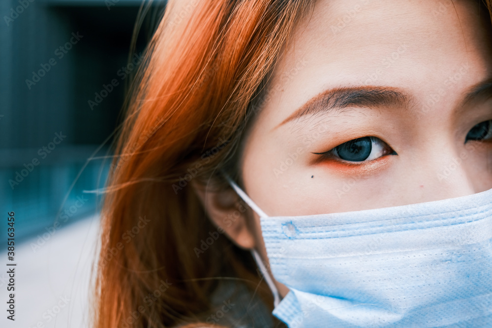 Young business woman wearing medical protective mask on the street Young business woman wearing medical protective mask on the street